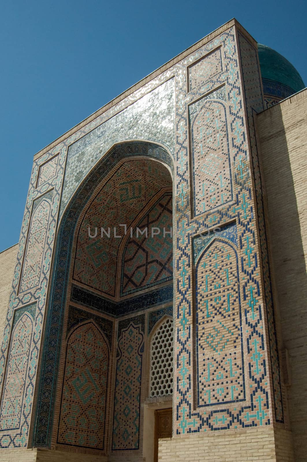 The arch and the exterior design of the ancient Registan in Samarkand. Ancient architecture of Central Asia