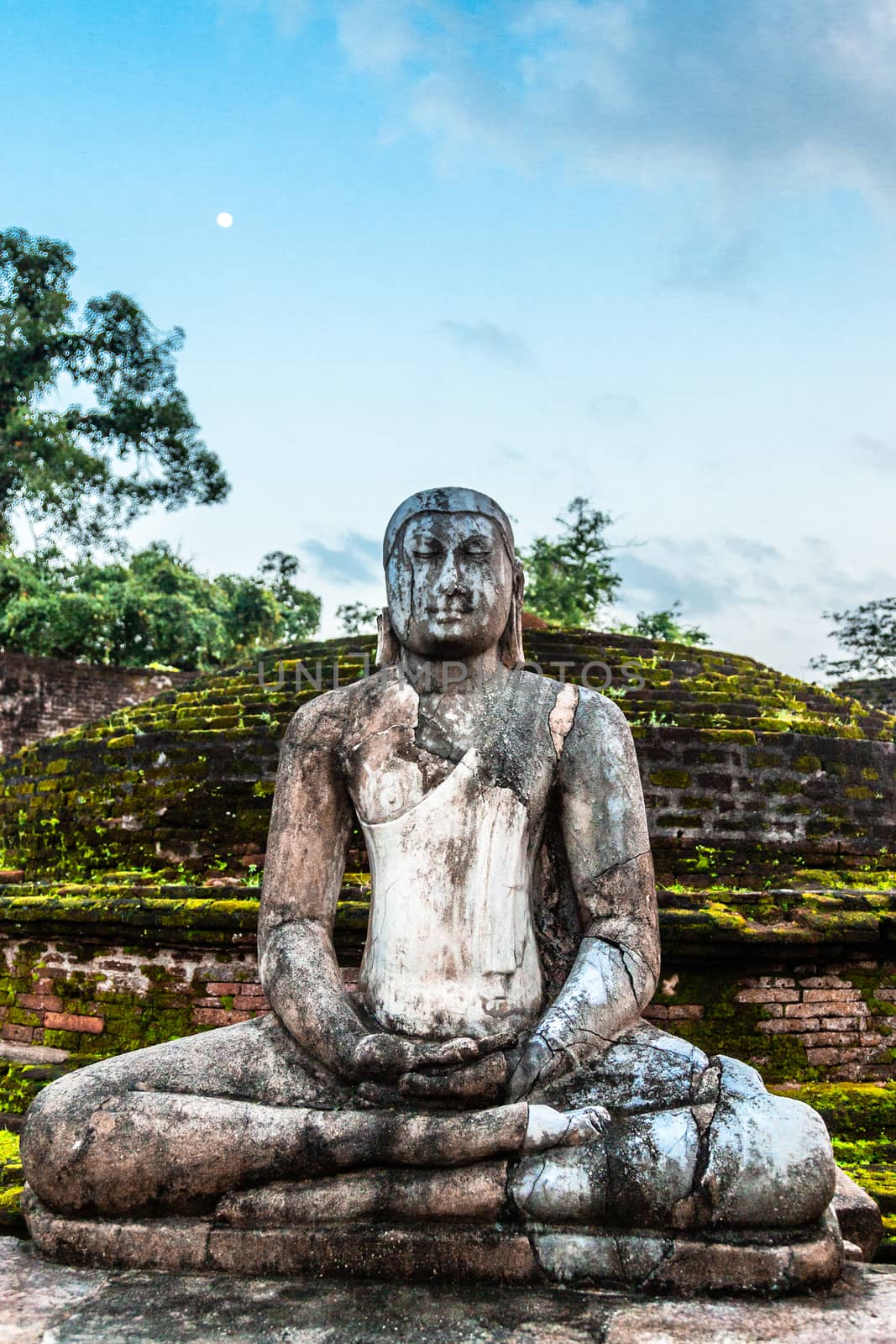 Meditating buddha statue in ancient city of Polonnaruwa, North C by ambeon