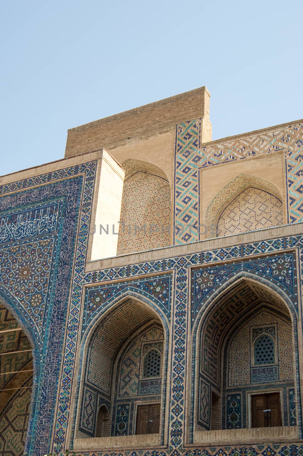 The arch and the exterior design of the ancient Registan in Samarkand. Ancient architecture of Central Asia