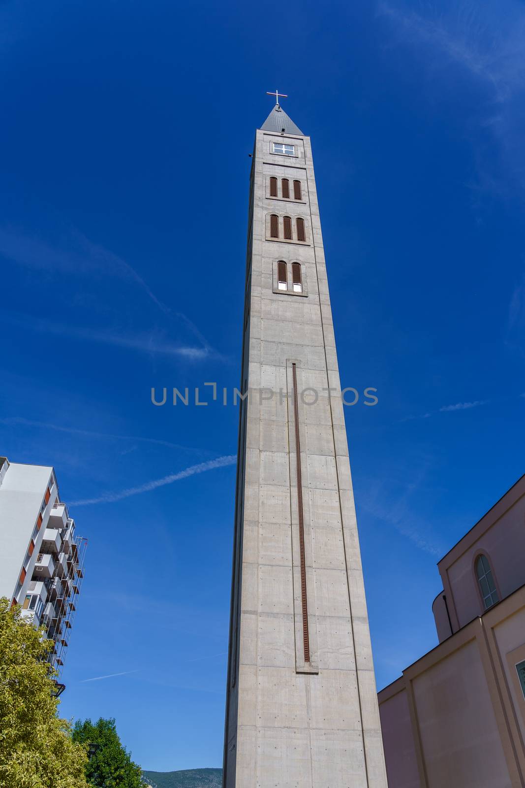 High building of the temple in the city of Mostar in Bosnia against a blue sky.