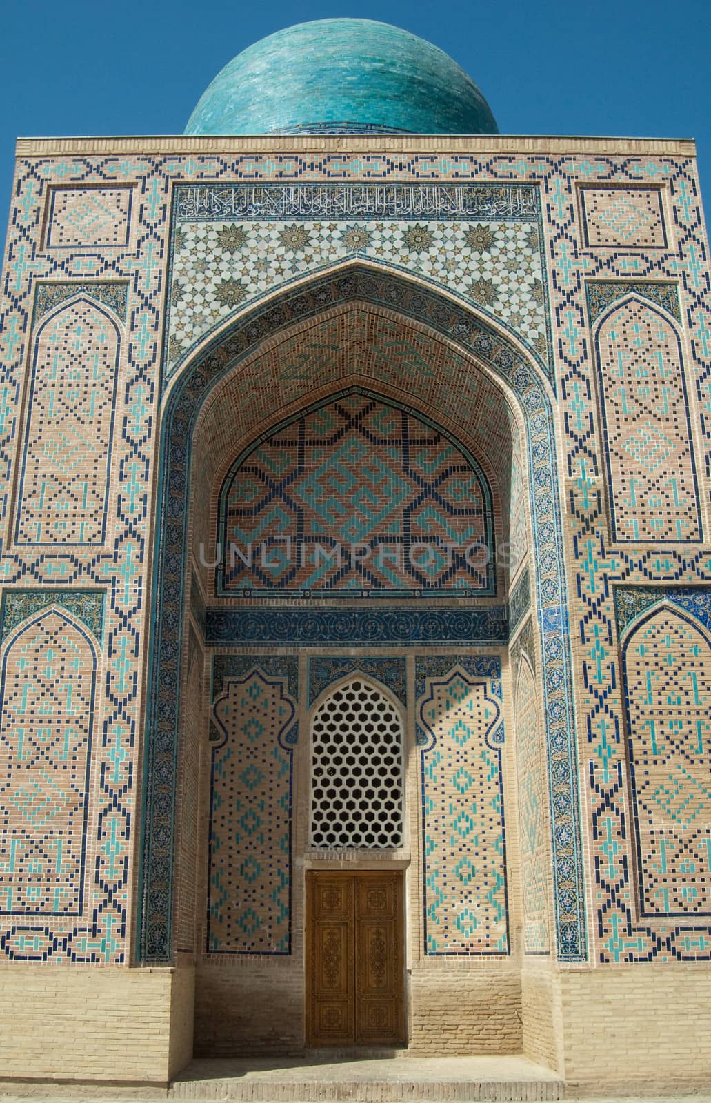 The arch and the exterior design of the ancient Registan in Samarkand. Ancient architecture of Central Asia