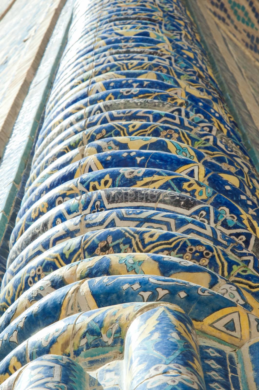 Fragment of a column in the wall with the mosaic. the details of the architecture of medieval Central Asia