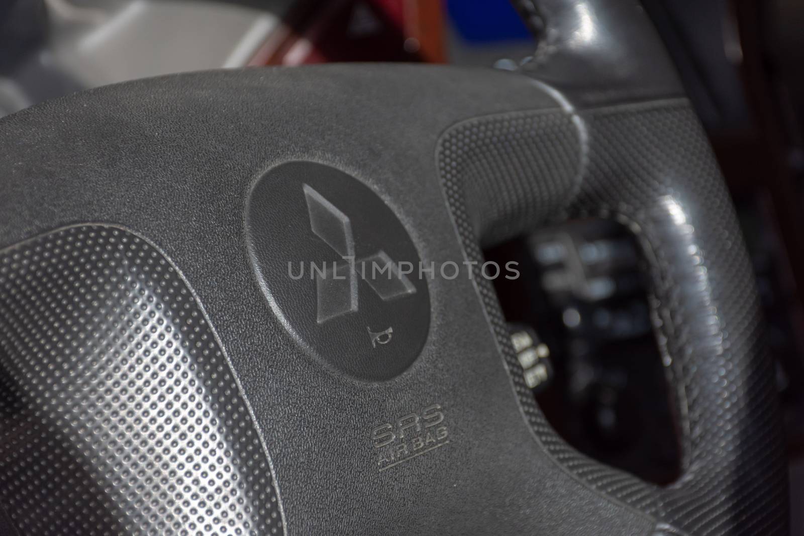 "Northern Emirate, RAK/UAE - 3/30/2019: "A Mitsubishi Pajero interior shot of black steering wheel and logo."