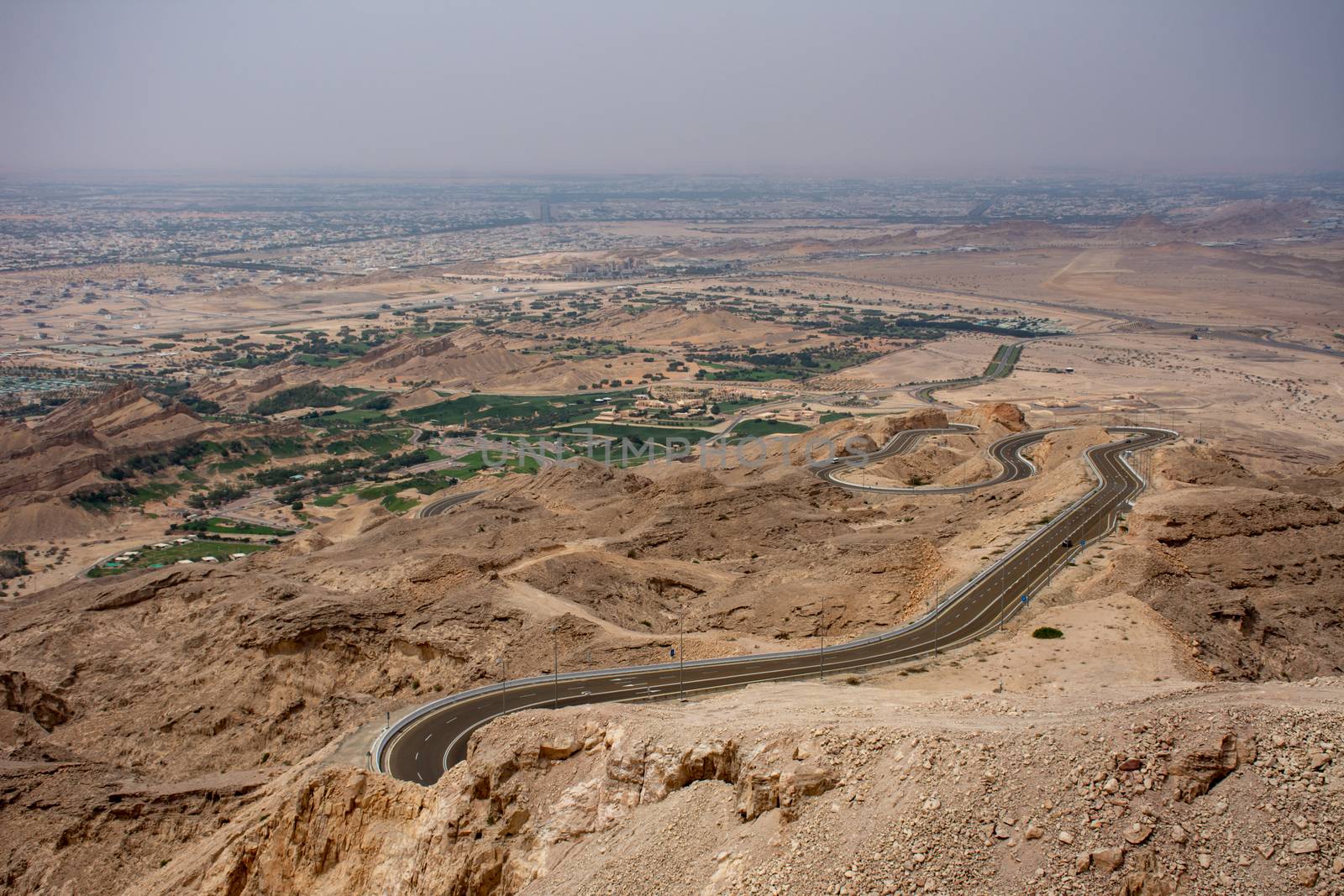 Viewpoint of twisted highway on Jebal Hafeet (aka Jebel Hafit) and Green Mubazzarah Park in Al Ain, UAE.