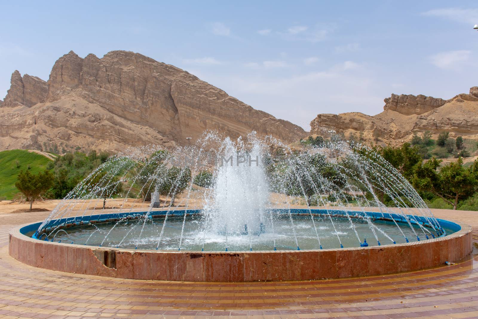 Green Mubazzarah Park Fountain on the top of the hill viewpoint. by kingmaphotos