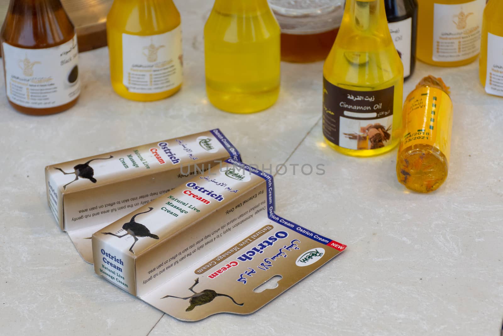 "Dubai, Dubai/United Arab Emirates - 4/6/2019: Ostrich massage cream for sale at Global Market in Dubai, United Arab Emirates. sitting on a table in a package with other oils and products."