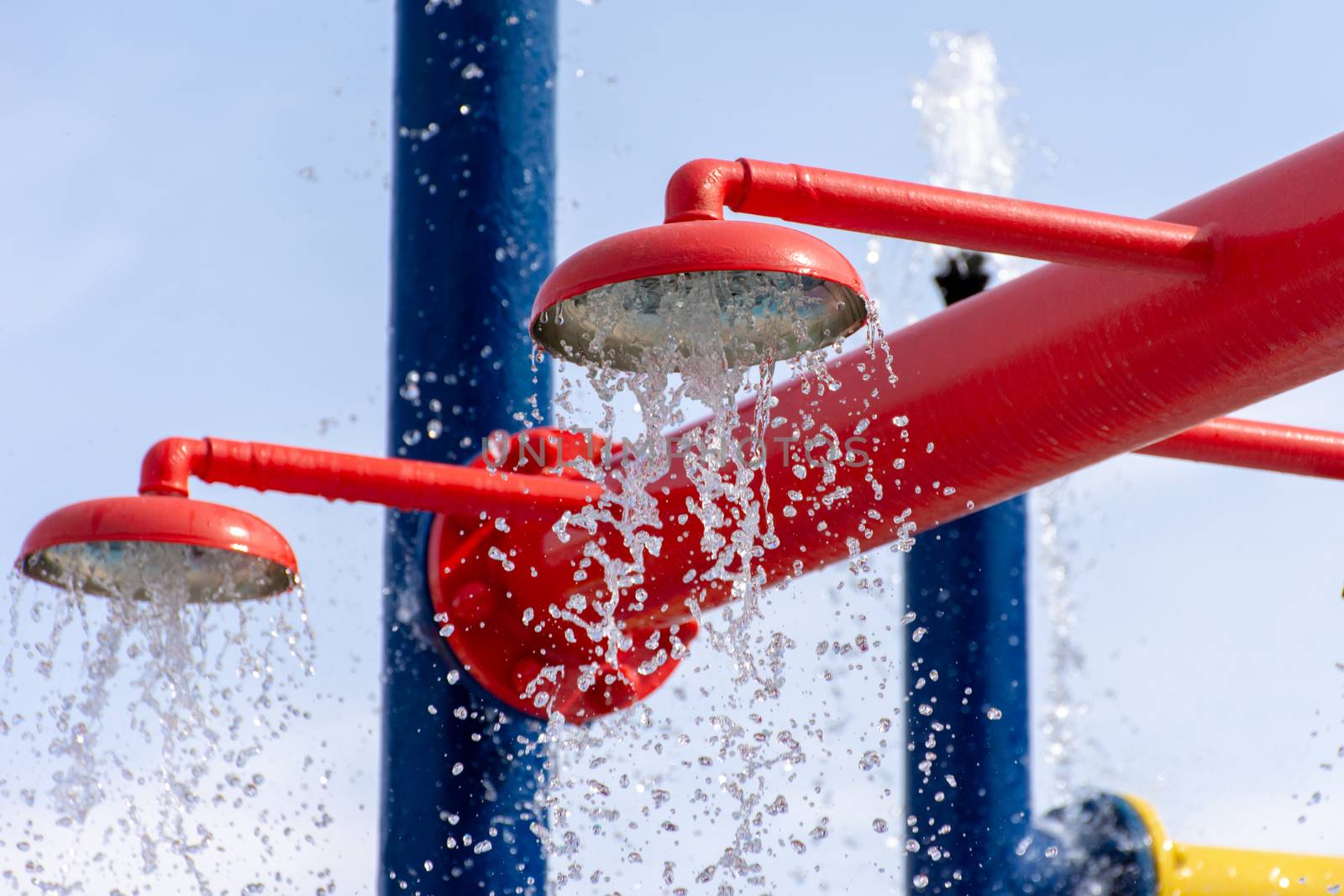 Summertime fun for the kids at the splash pad to play with water falling from bright colored fountains.