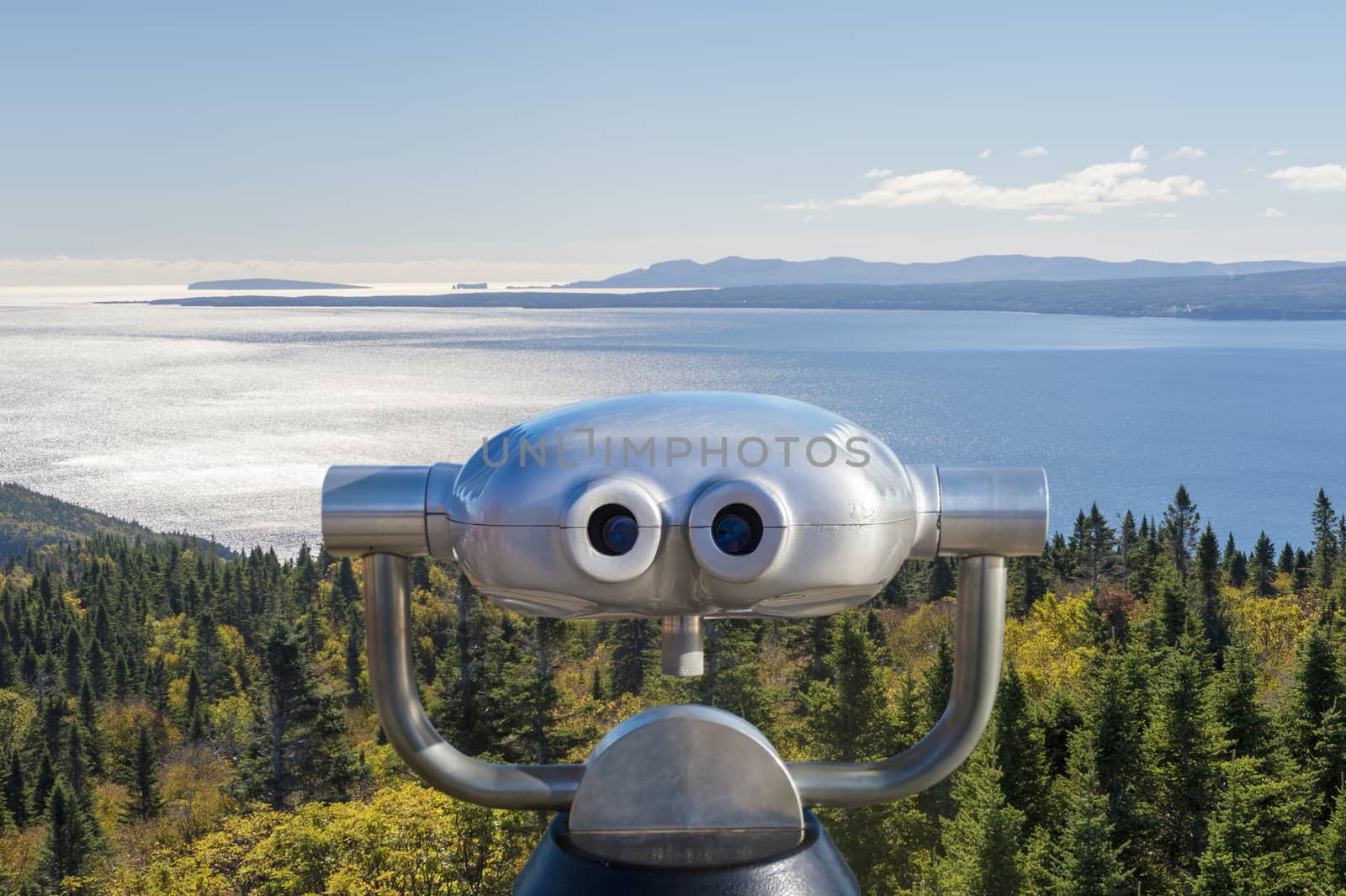 Public binoculars in front of a view over the Forillon National  by mbruxelle