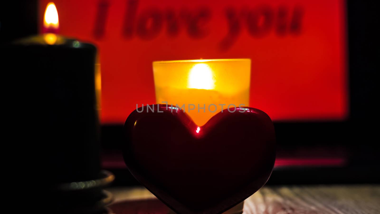 Red heart close-up on the background of the inscription I love you. gifts for Valentine's Day. mother's day greeting card. International women day. red heart with candles, Declaration of love.