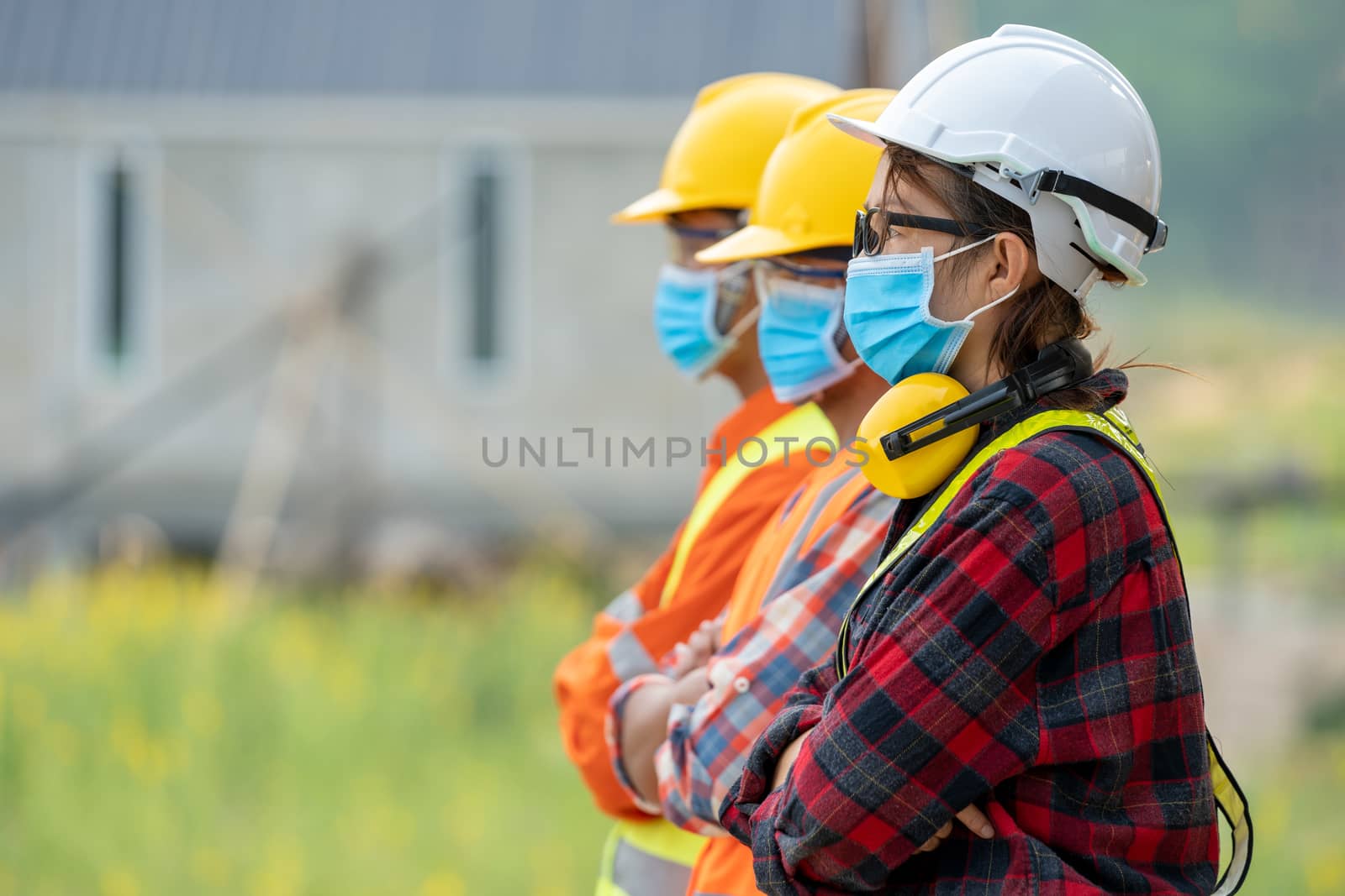 Group of Asian engineers wearing protective mask to Protect Against Covid-19 with helmet safety in the construction site,Coronavirus has turned into a global emergency,Safety concept.