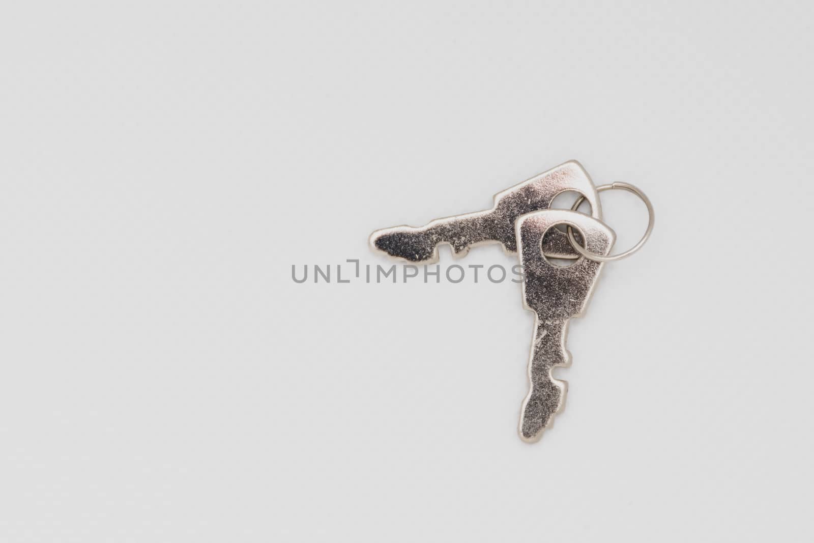 Two keys isolated on a white background spread out. Open space a by kingmaphotos