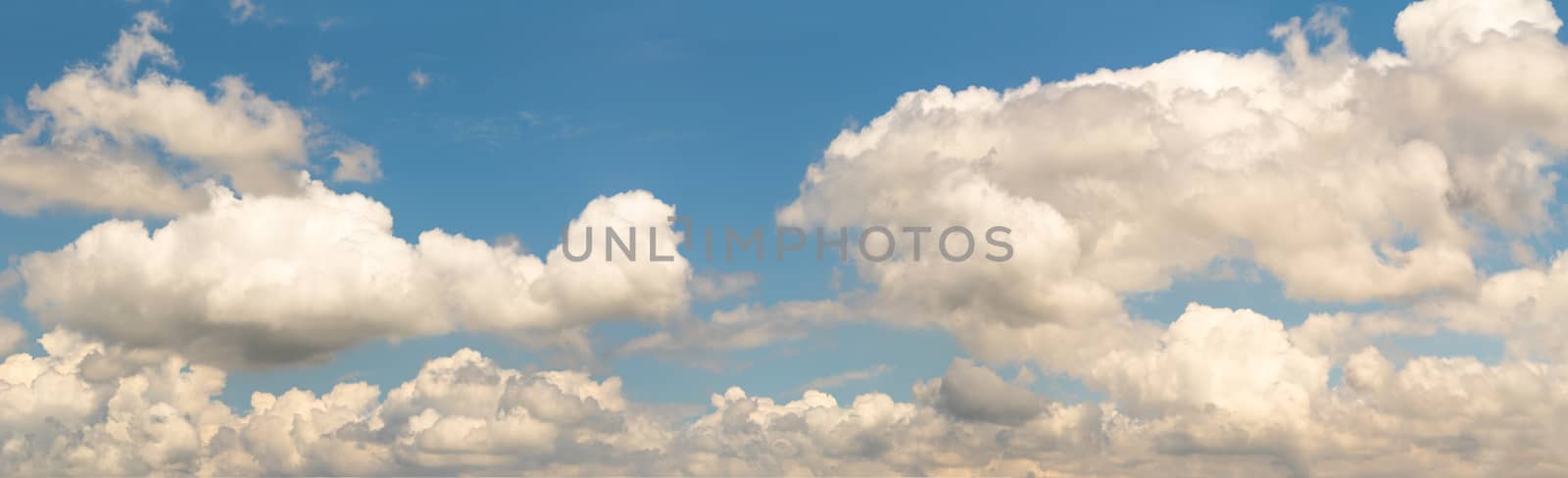 Panoramic white fluffy clouds in the blue sky, Fantastic soft white clouds against blue sky