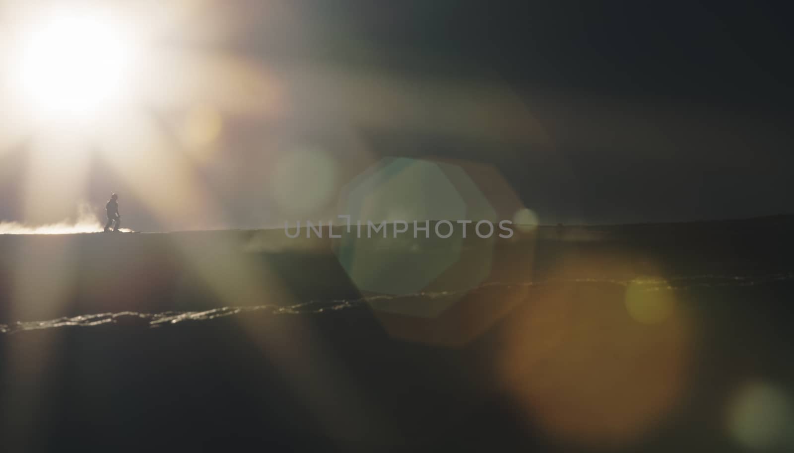 Skier enjoying an early morning in slopes at the Austrian Alps with a nice sunshine flare