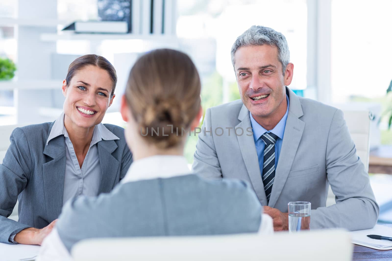 Business people interviewing young businesswoman by Wavebreakmedia