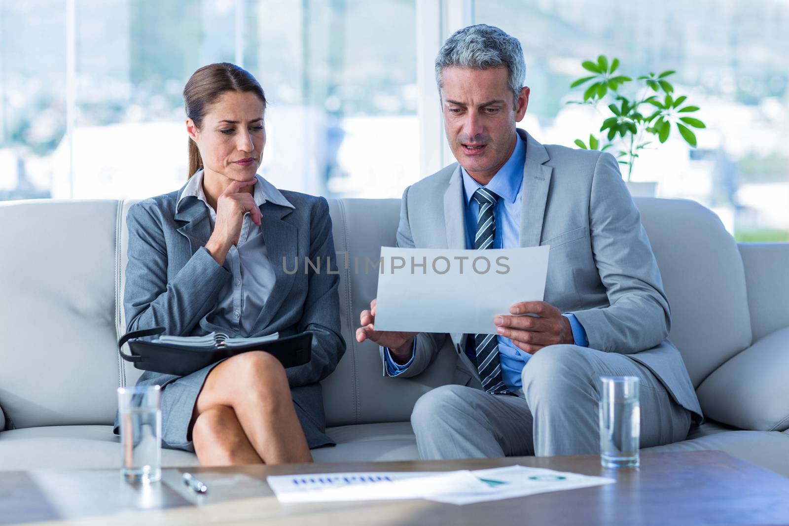 Business people looking at documents in office 