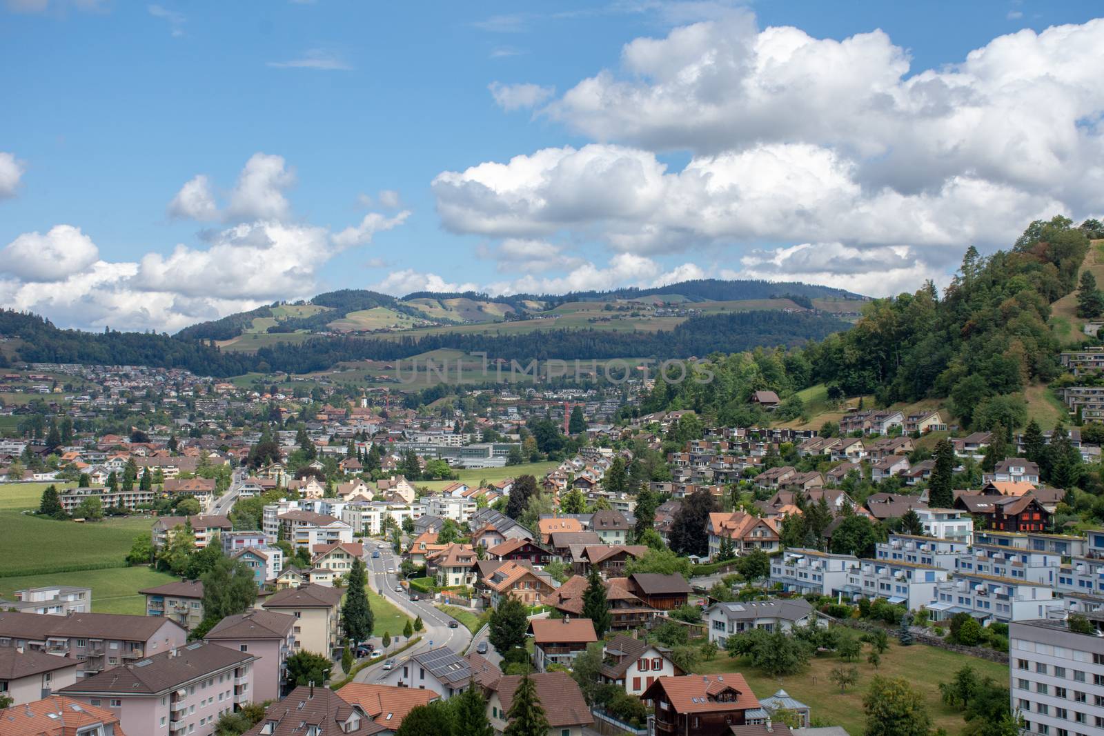 European town of Thun, Switzerland in the summer with cottages, castles, houses, and mountains.