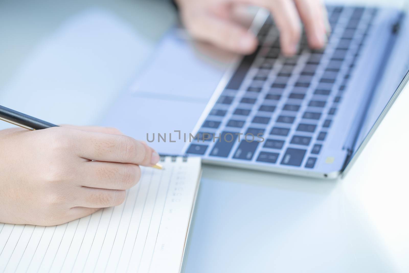 Woman working at home office using laptop searching web, browsing information ,Hand on keyboard close up