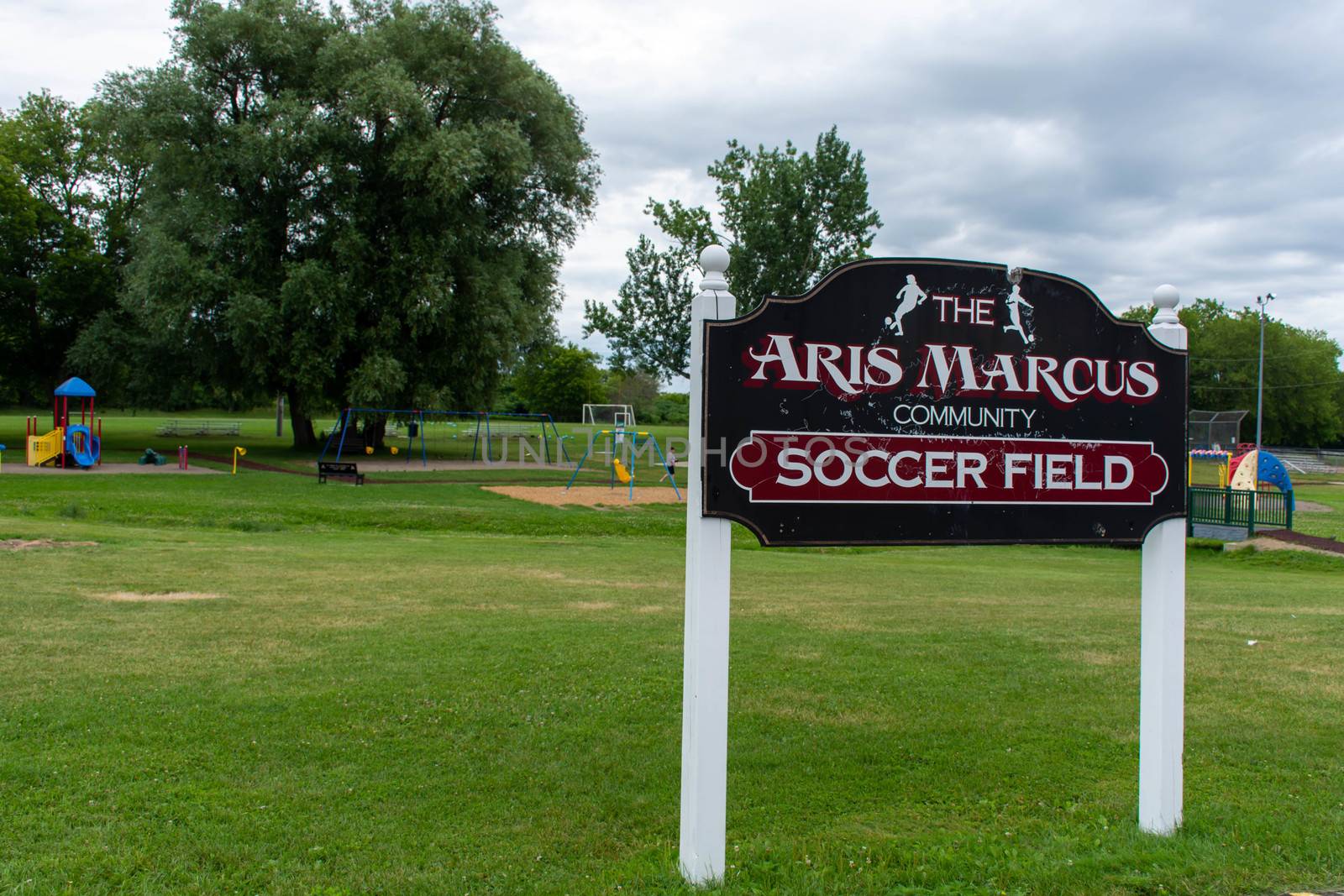 "Brighton, Ontario/Canada - 07/22/2019: Aris Marcus community soccer field sign for park in a small town Canadian city of Brighton near Pesquile Lake Provincial Park ."
