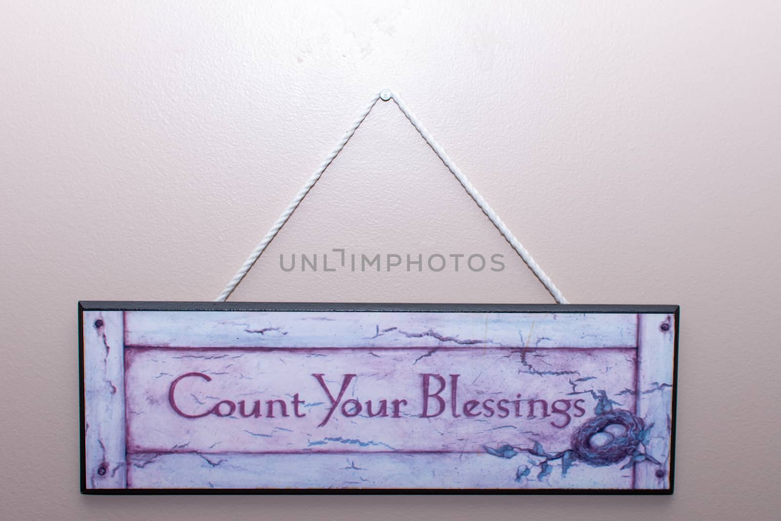 Count your blessings sign hangs on the wall in a home to remembe by kingmaphotos