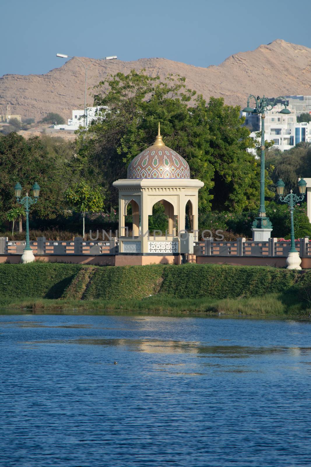 Qurm Park in Muscat, Oman in the evening looking at the lake and mountains on a quiet winter day.