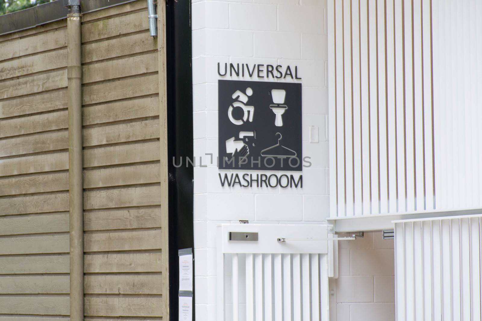 Universal bathroom or washroom sign in a public park in Canada. A controversial topic surrounding transgender rights and issues.