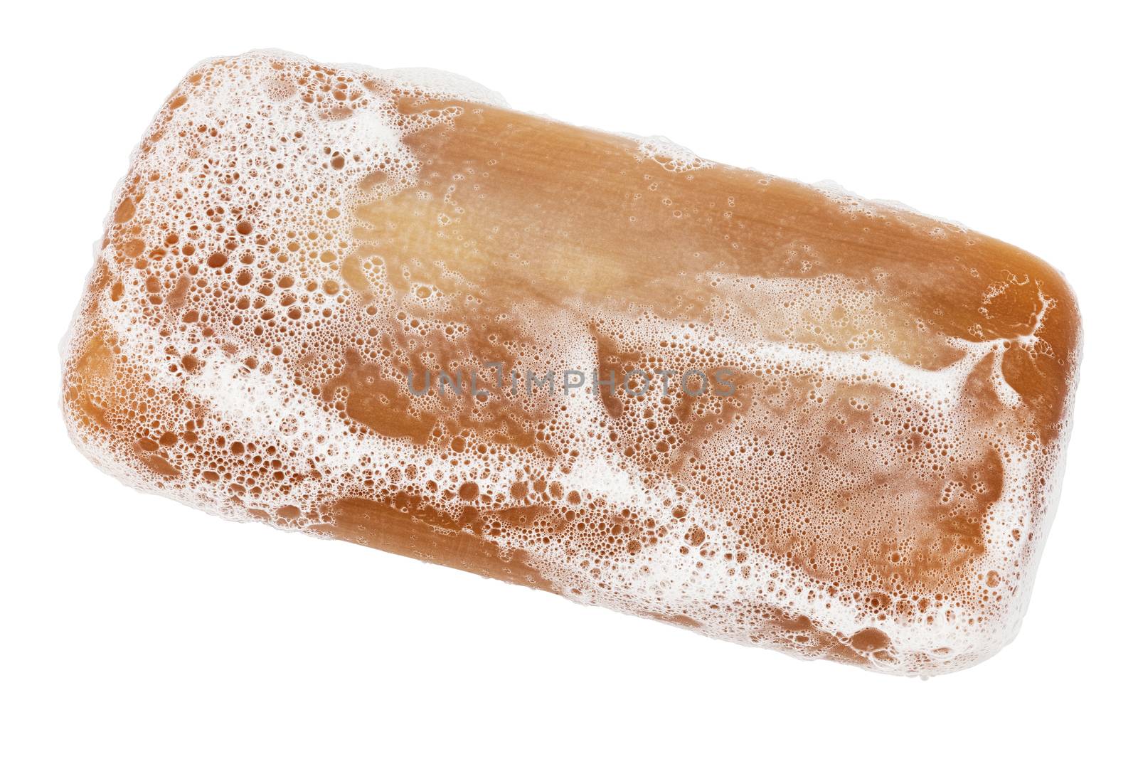 wet piece of brown tar soap with sud foam isolated on white background in diagonal perspective view