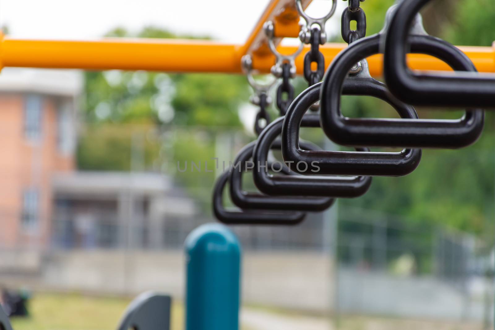 Empty monkey bars at a playground concept looking through at goa by kingmaphotos