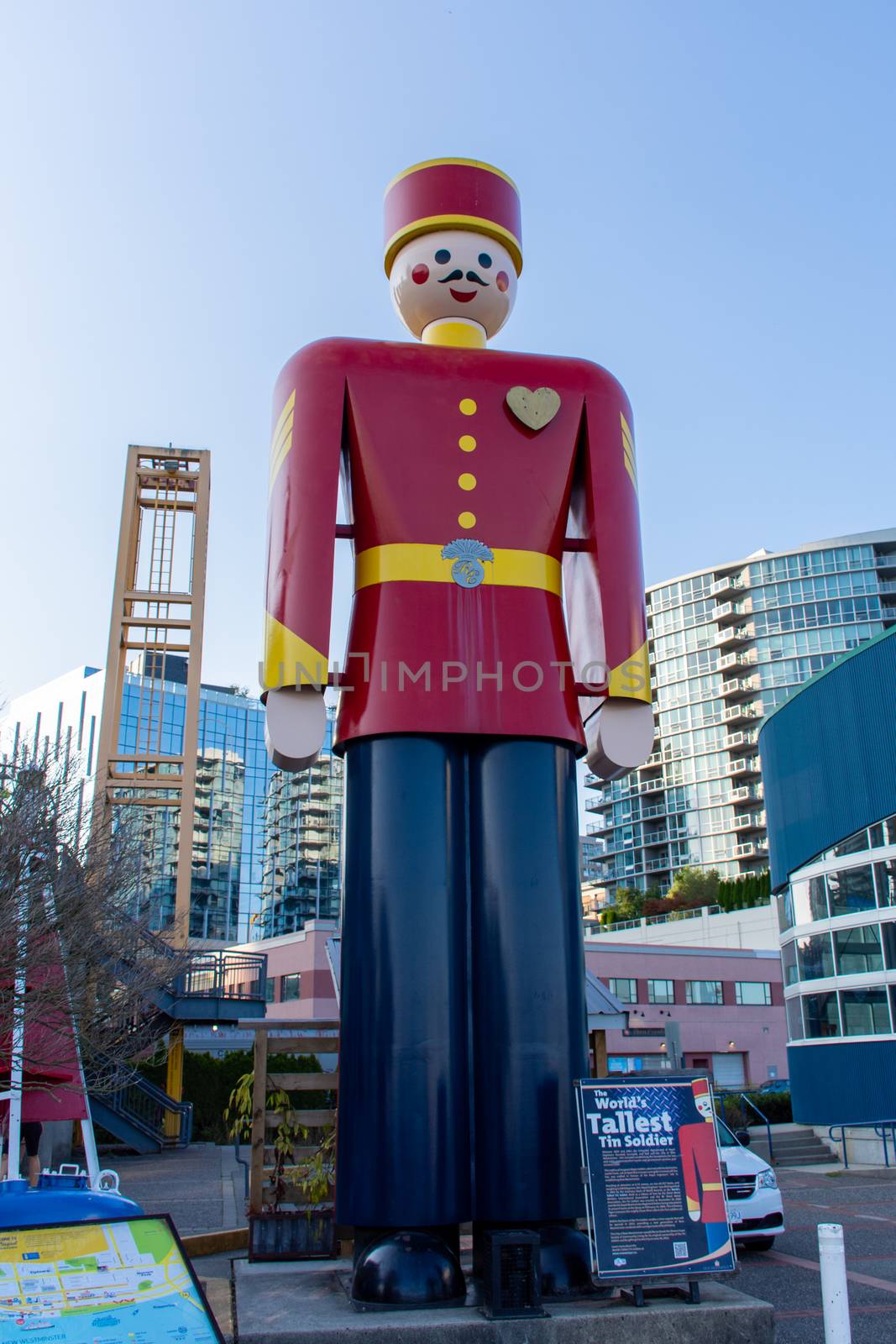 "New Westminster, British Columbia/Canada - 8/3/2019: On the Quay, a Statue of the world's tallest tin solder along the boardwalk in the evening summer sun."