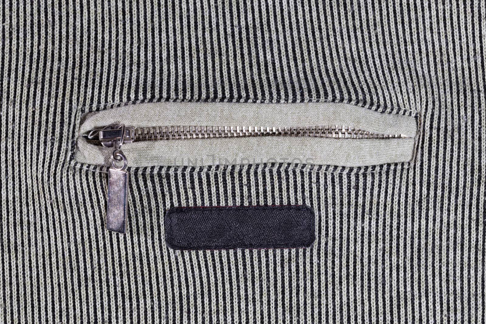 abstract vertical striped texture of flat fabric surface with zip locking chest pocket, and black blank label by z1b