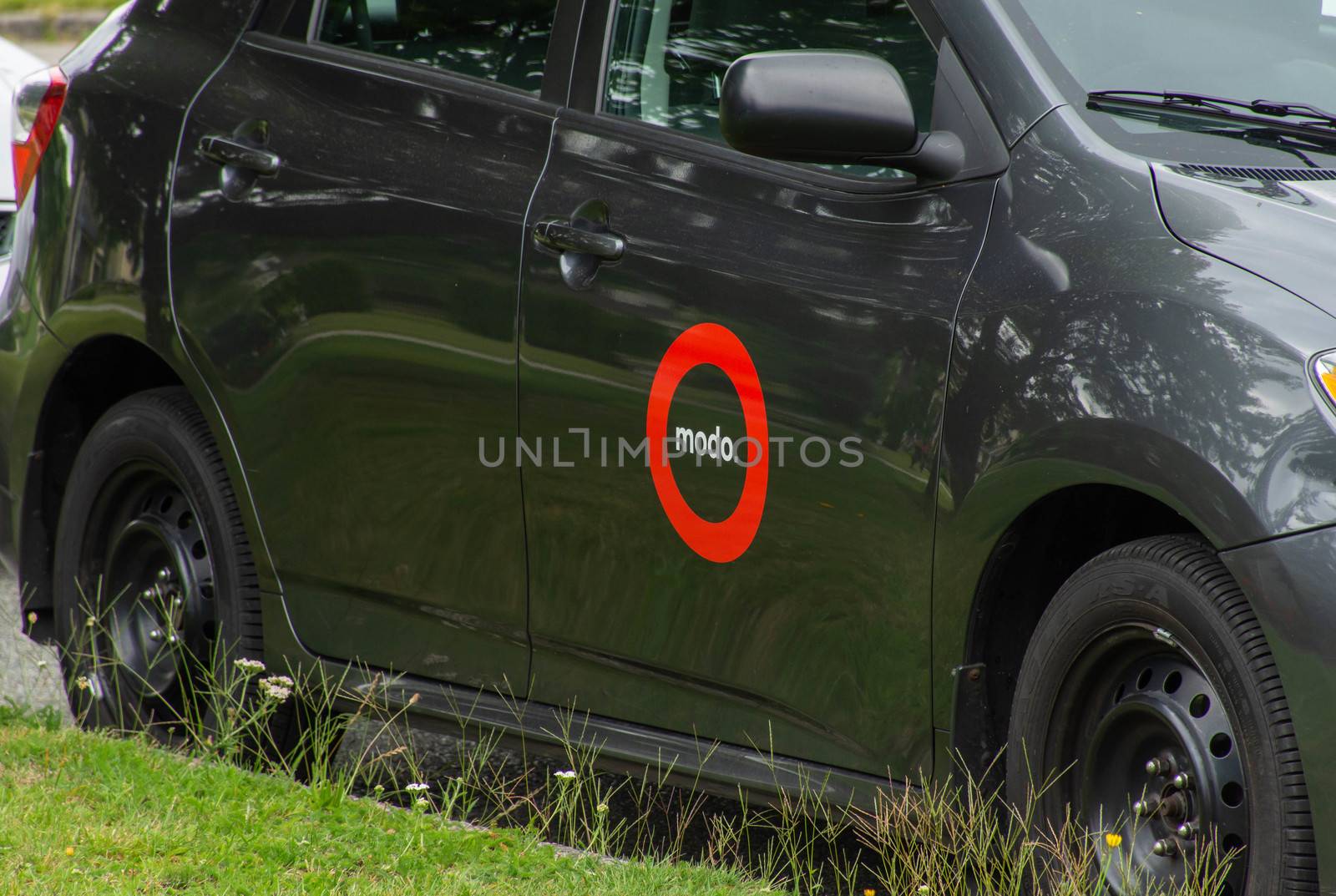 "New Westminster/ British Columbia, Canada - 07/24/2019: Modo Car Share a Carpooling car parked on the street used for short term rentals to save environment."