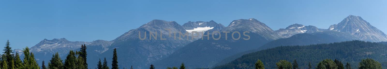 Whistler Mountain Panorama in British Columbia, Canada in the summer sun and blue sky looking at mountain range