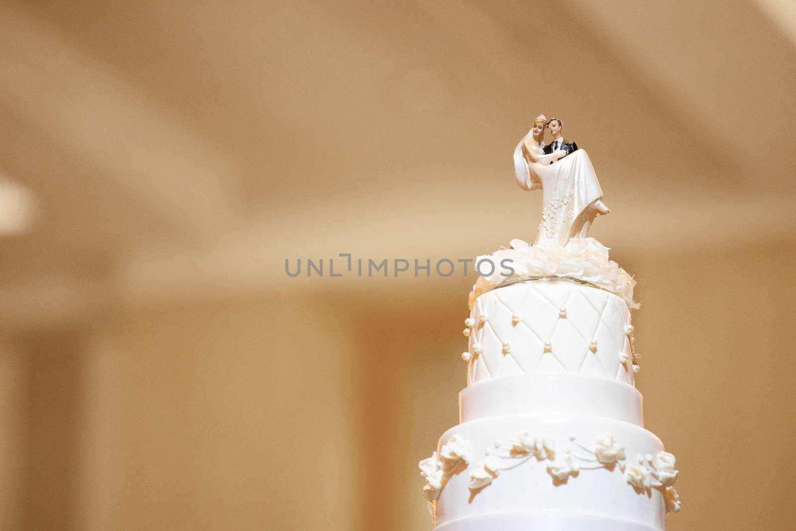 wedding cake with bride and groom dolls on top with blank copyspace