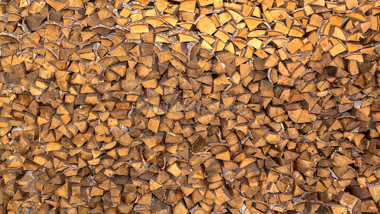 Pile of firewood for the fireplace, oven. A wall of stacks. Log, timber, fire, texture,