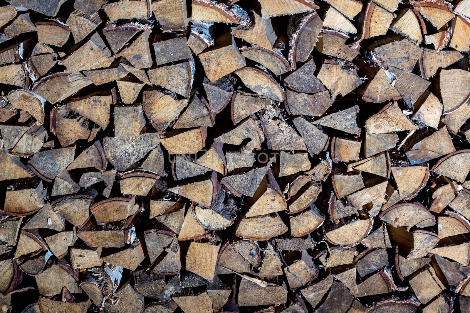 Pile of firewood for the fireplace, oven. A wall of stacks. Log, timber, fire, texture,