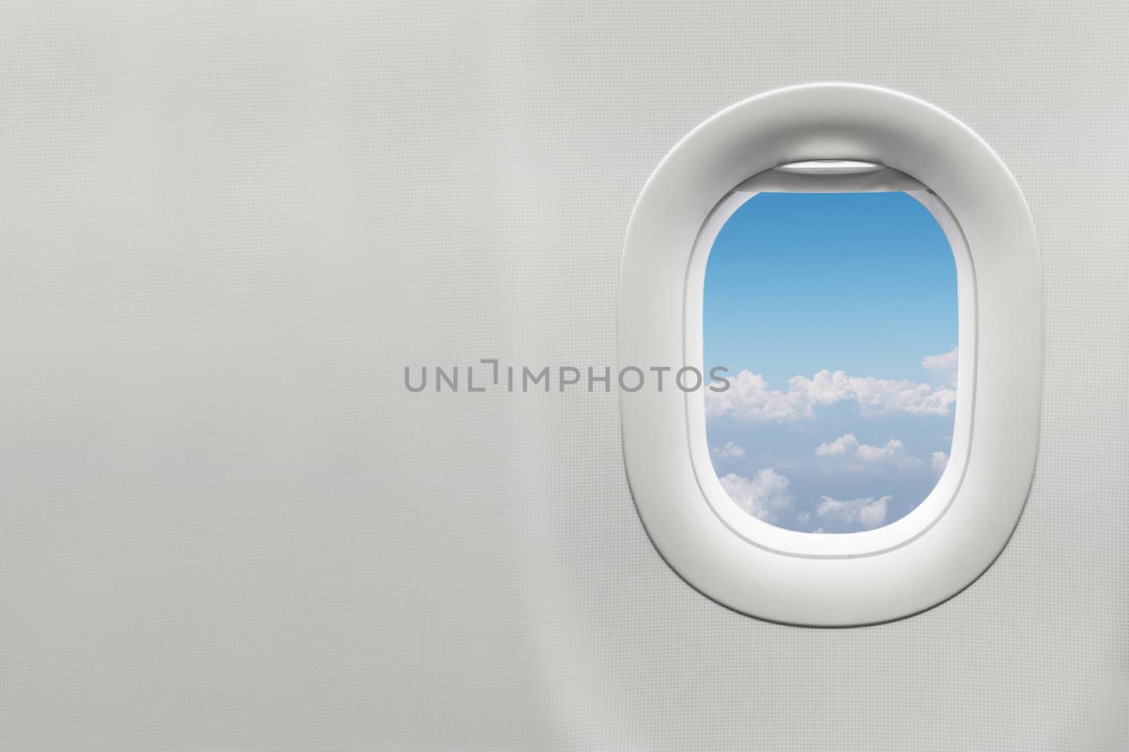 Isolated airplane window with blue sky by Charnsitr