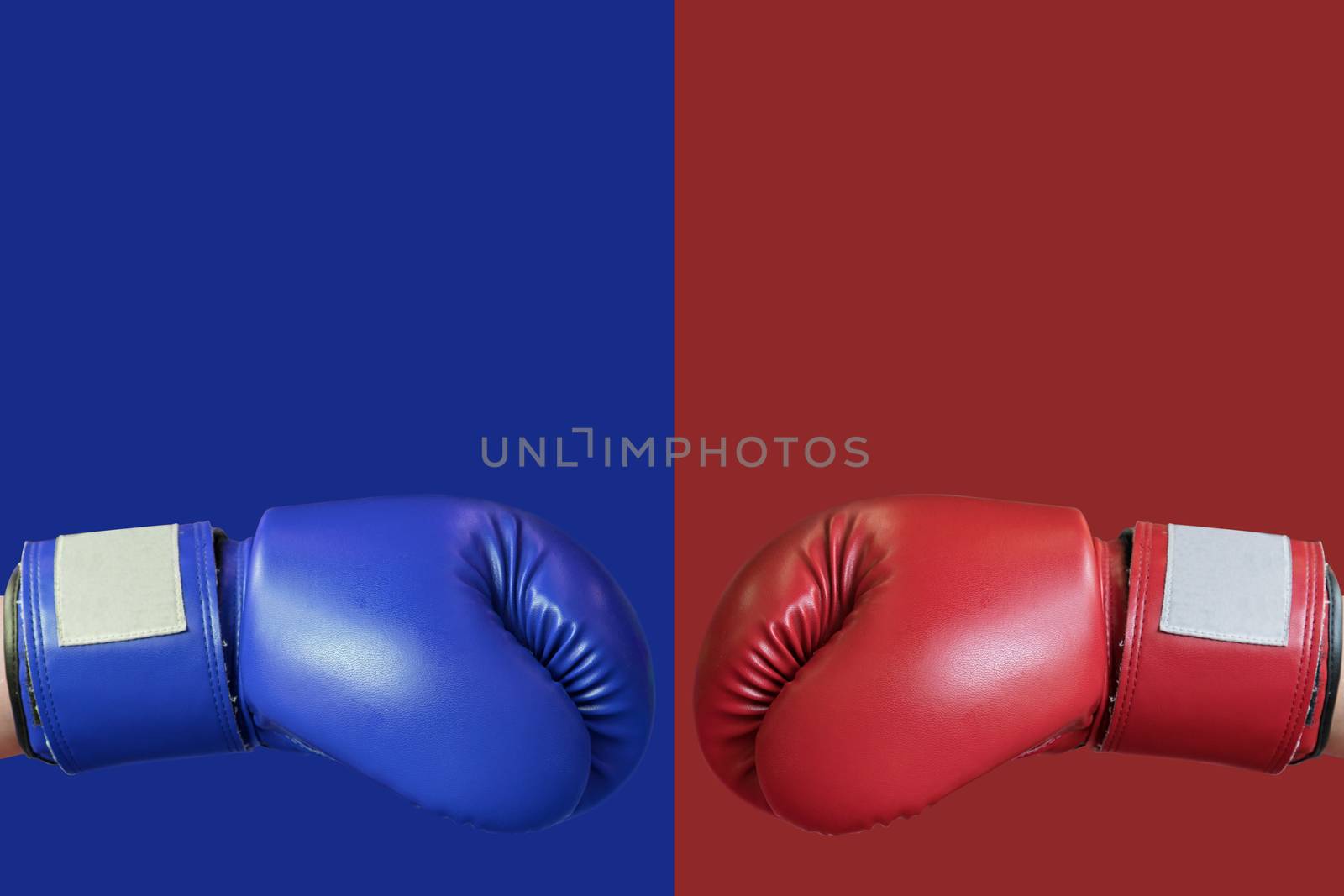 boxing glove in red and blue corner for fight and comparing the  by Charnsitr