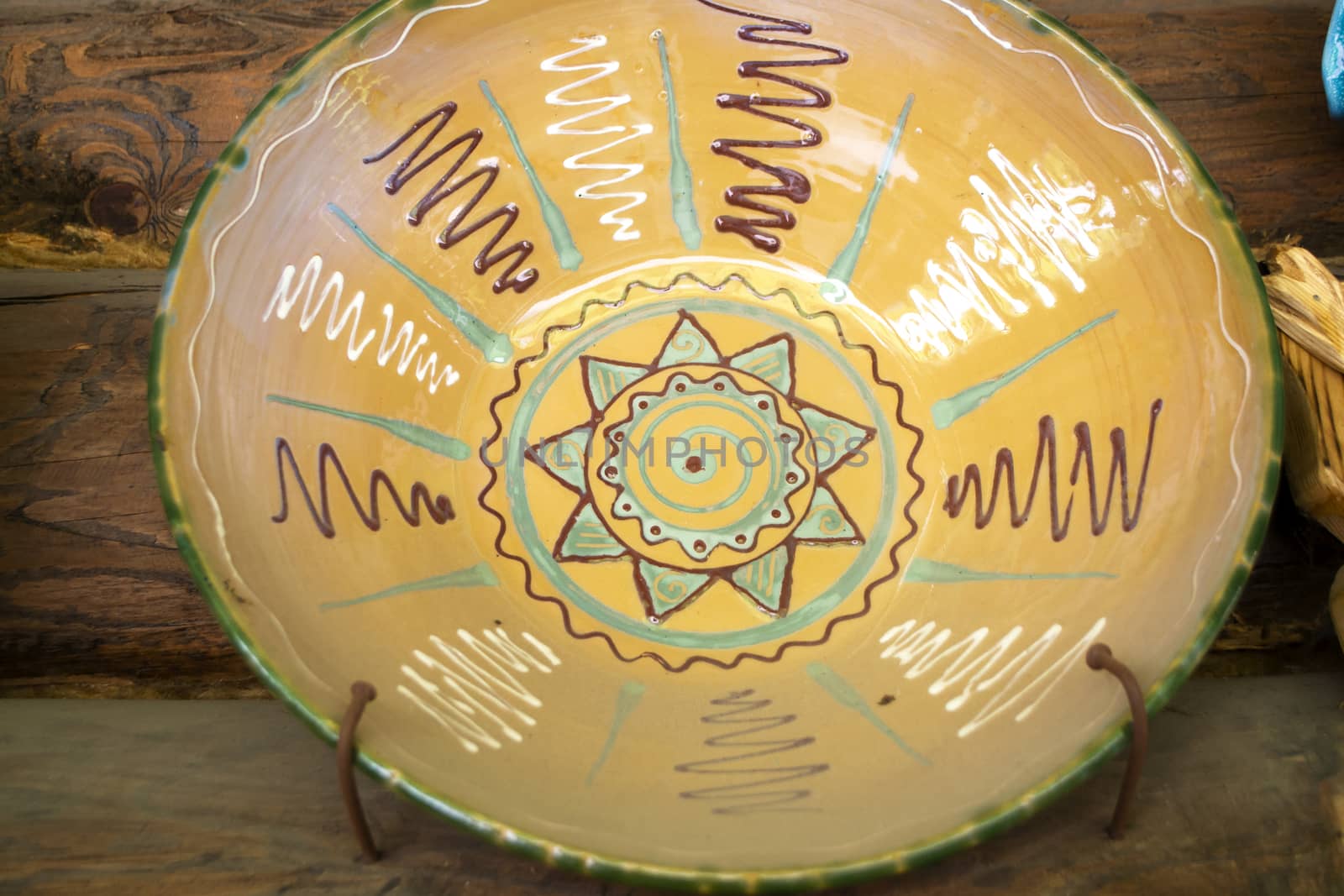 Authentic ceramic dish of Belarus with traditional pattern, on rustic wooden background