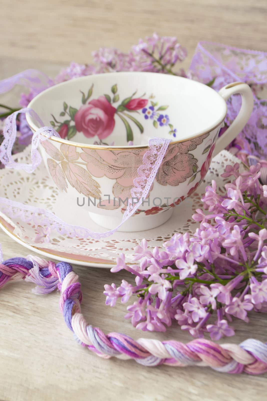Lilac flowers with vintage cup, violet and purple colors, vertical image