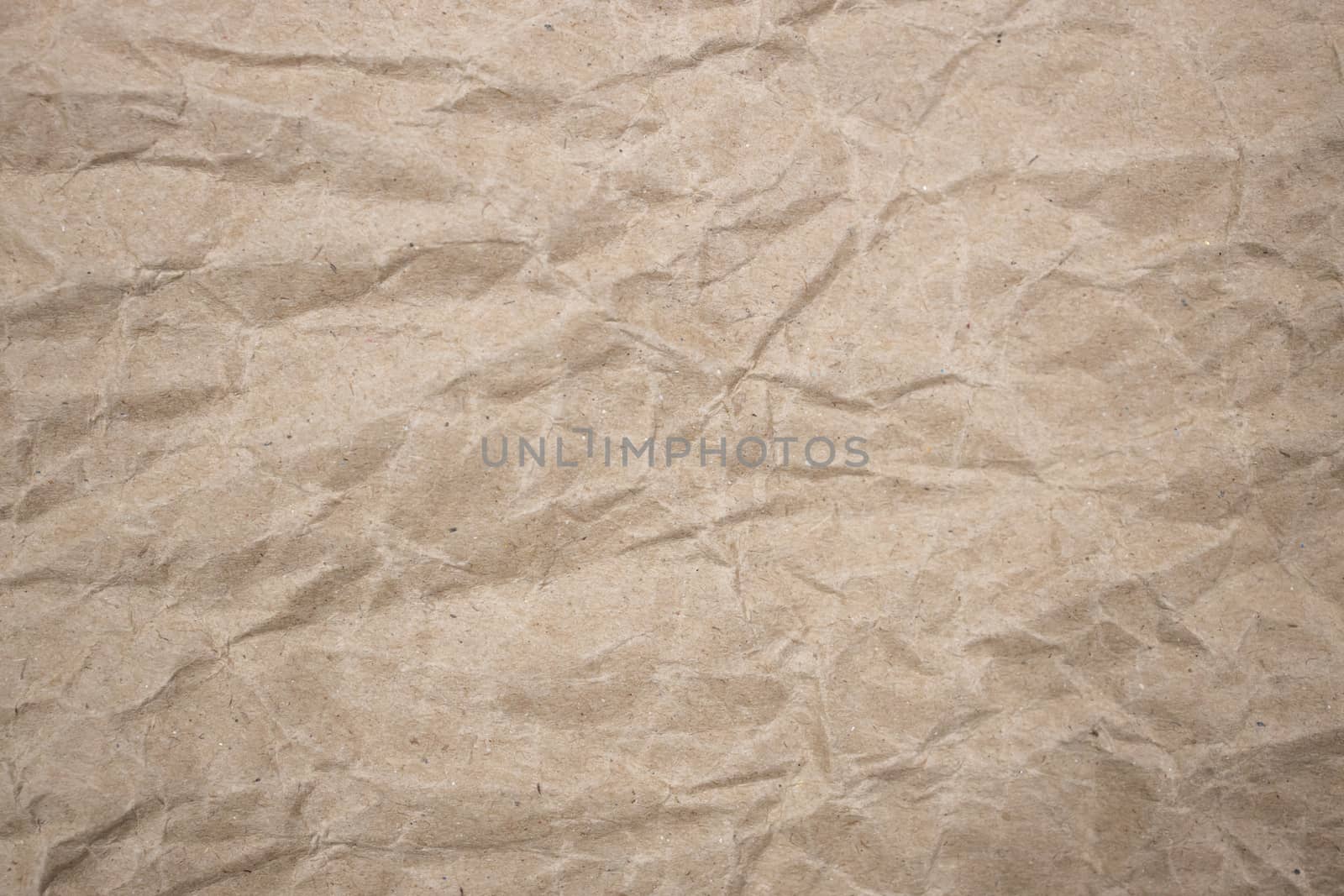 background of crumpled brown paper texture by Charnsitr