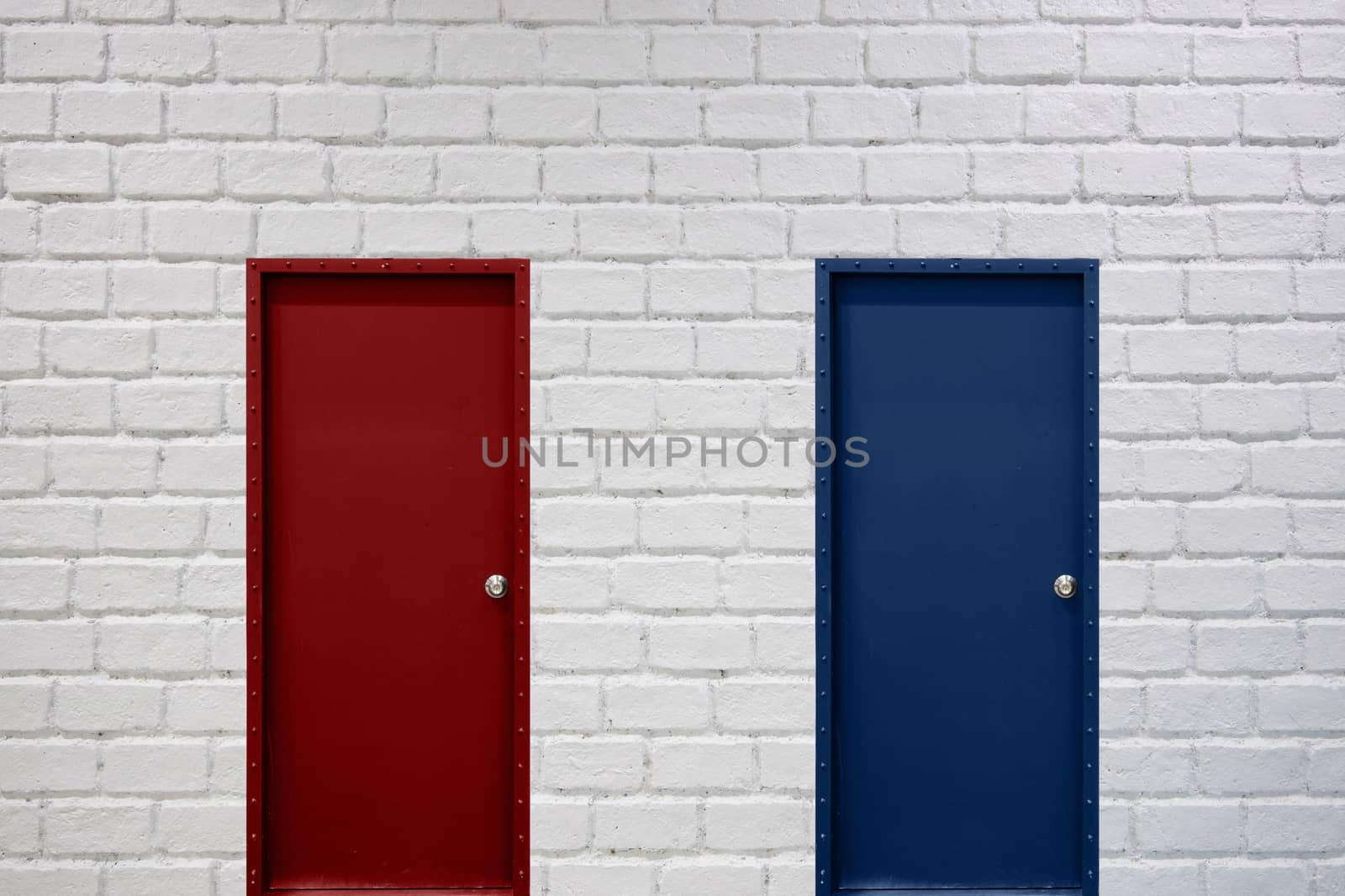 red and blue doors on white brick wall for business decision mak by Charnsitr