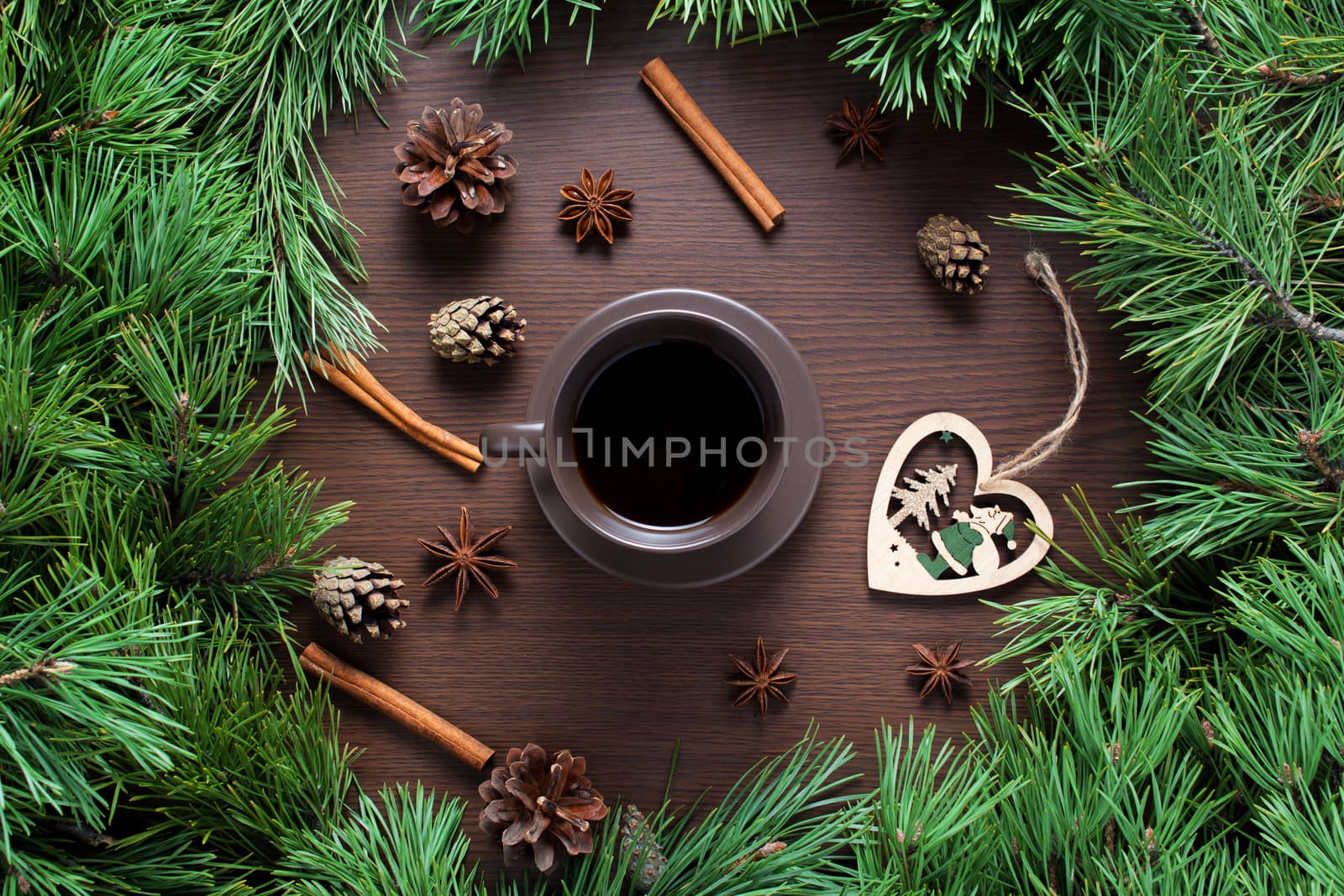 Christmas composition. A Cup of coffee, cones and Christmas toys on a wooden background. The decoration of Christmas wreaths. Winter, new year concept. Flat lay, top view
