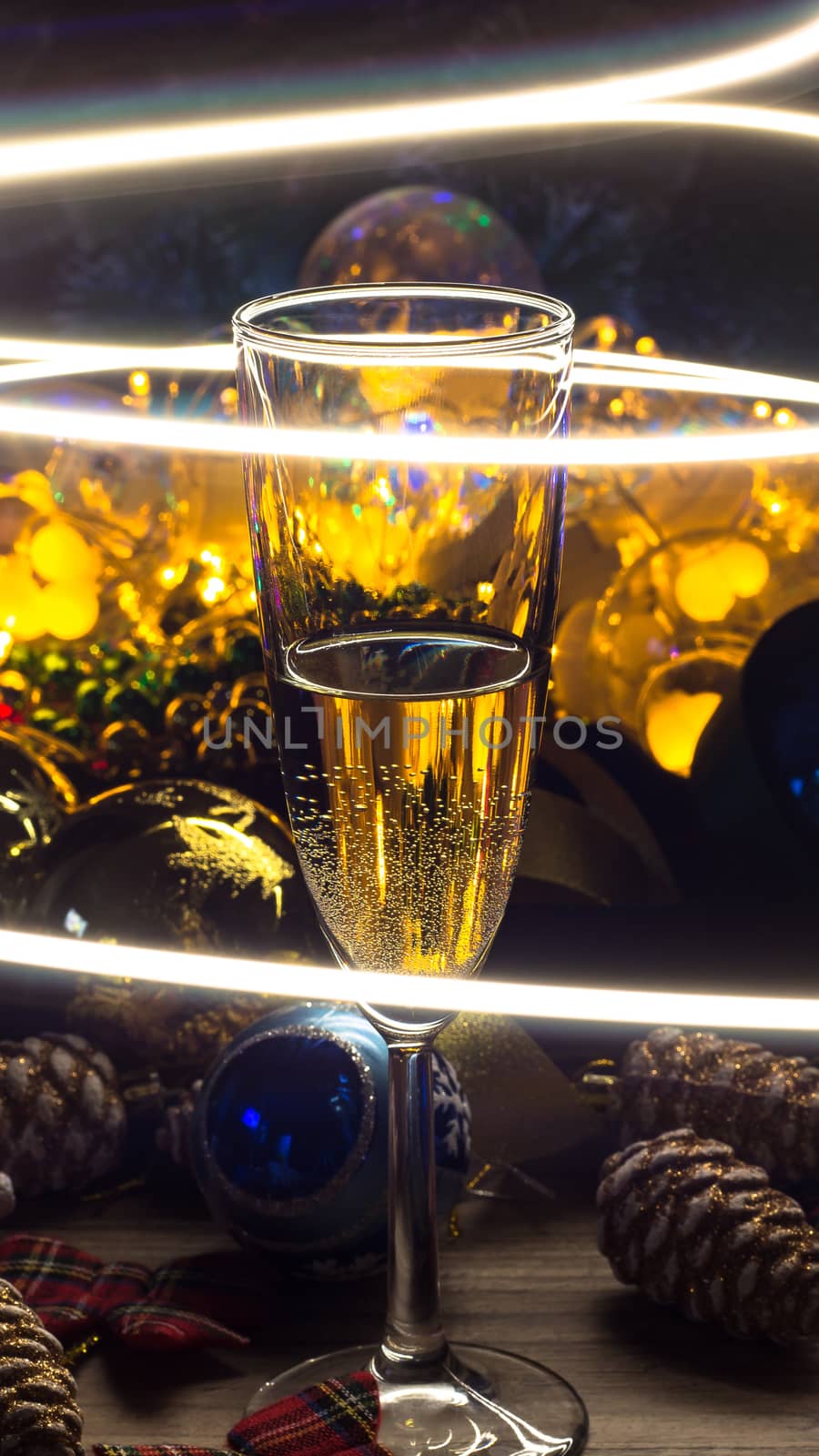 A glass of champagne on the Christmas decorations. happy New Yea by NataliSam