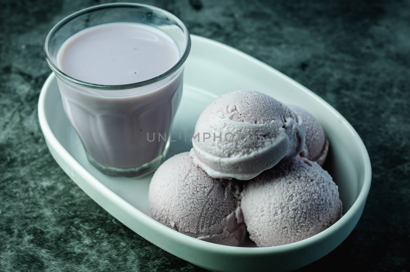 Homemade taro ice-cream and taro milk tea on a white plate. by wutiwong