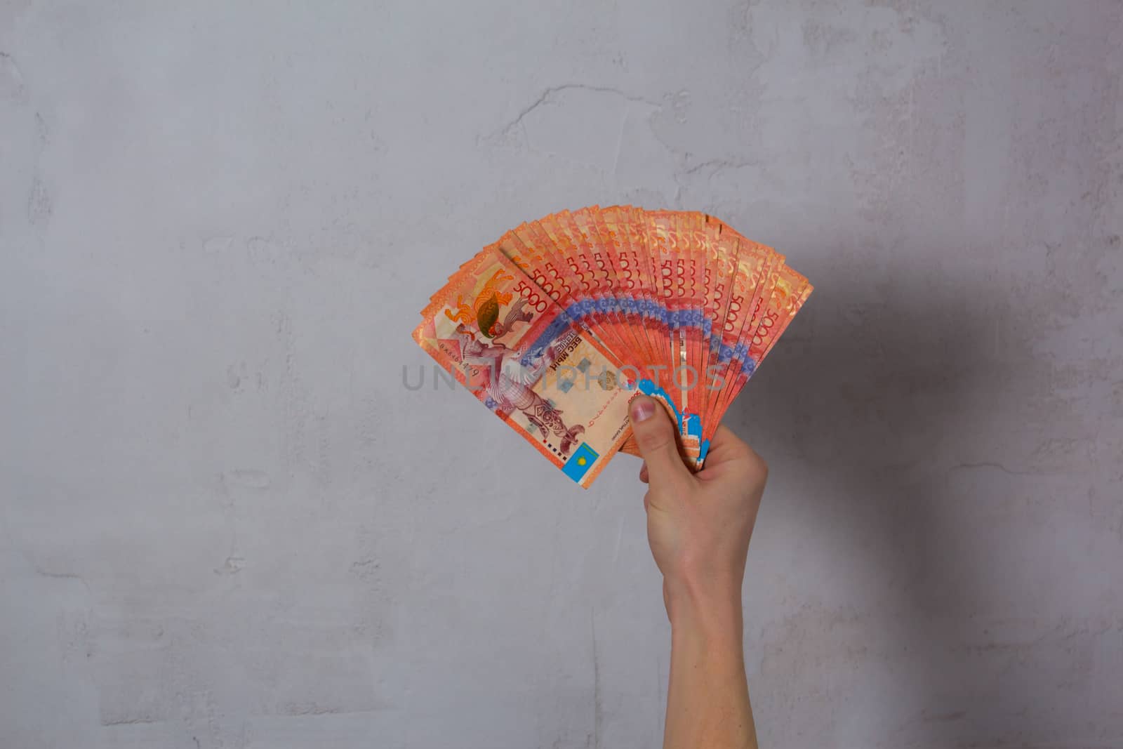 Hand hold a lot of money. Tenge KZT. National currency of Kazakhstan, KZ. Exchange rate. Economy, development, business, Bank, broker. Banknote