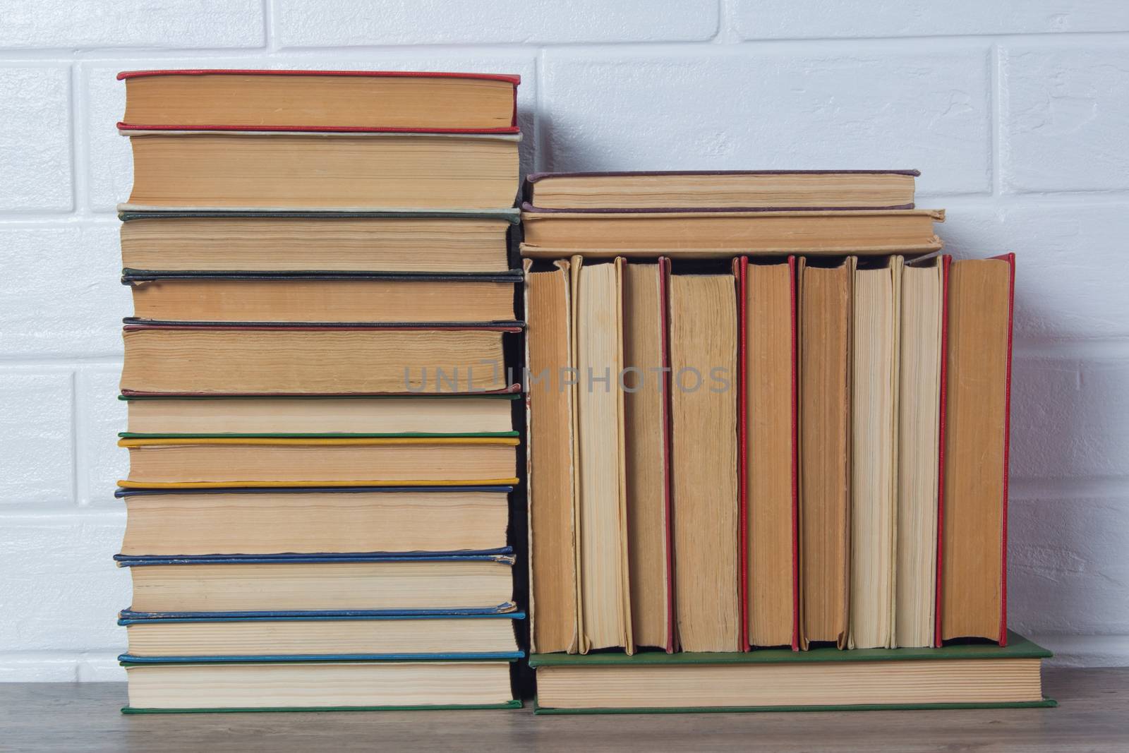 Stack of books. Hardcover books close-up. Bookshelf, bookstore, library. Multicolored covers. Reading, education, study. Retro, vintage, old.