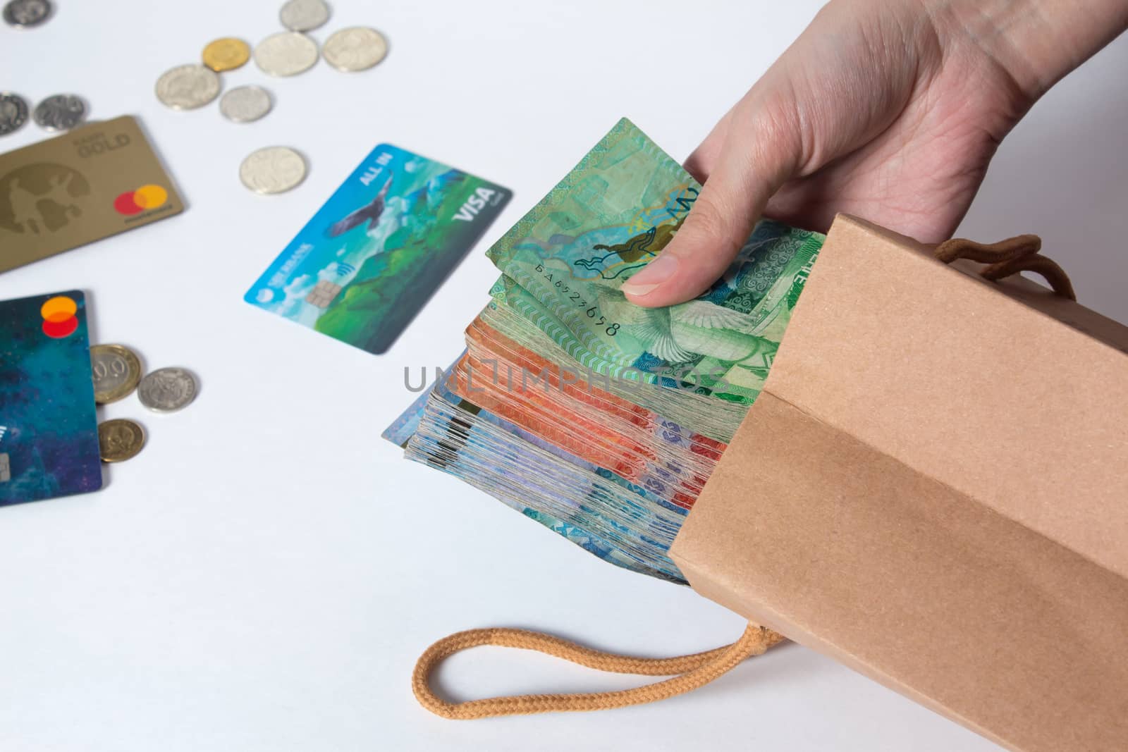 person pulls the money out of the bag. Tenge, Kazakhstan, banknote. Kraft package with paper currency. National currency of Kazakhstan, KZ. Exchange rate. Economy, development, business, Bank, broker