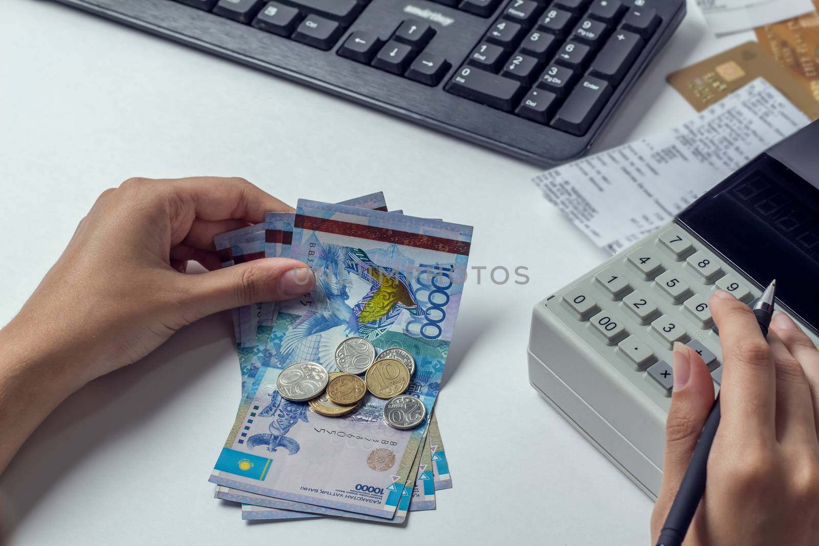 Tenge at the cashier accountant in the hands of the workplace in by YevgeniySam