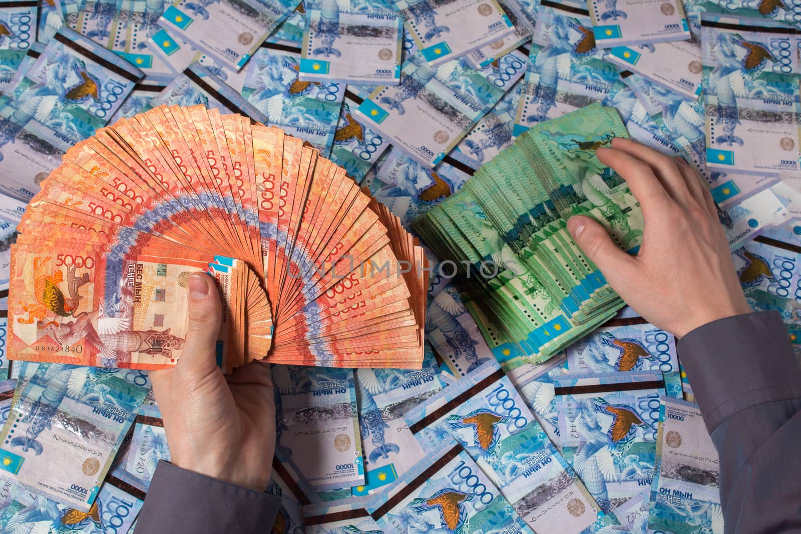 Hands holding Kazakhstani tenge money. Paper banknotes tenge KZT. Tenge is the national currency of Kazakhstan. bank of Kazakhstan