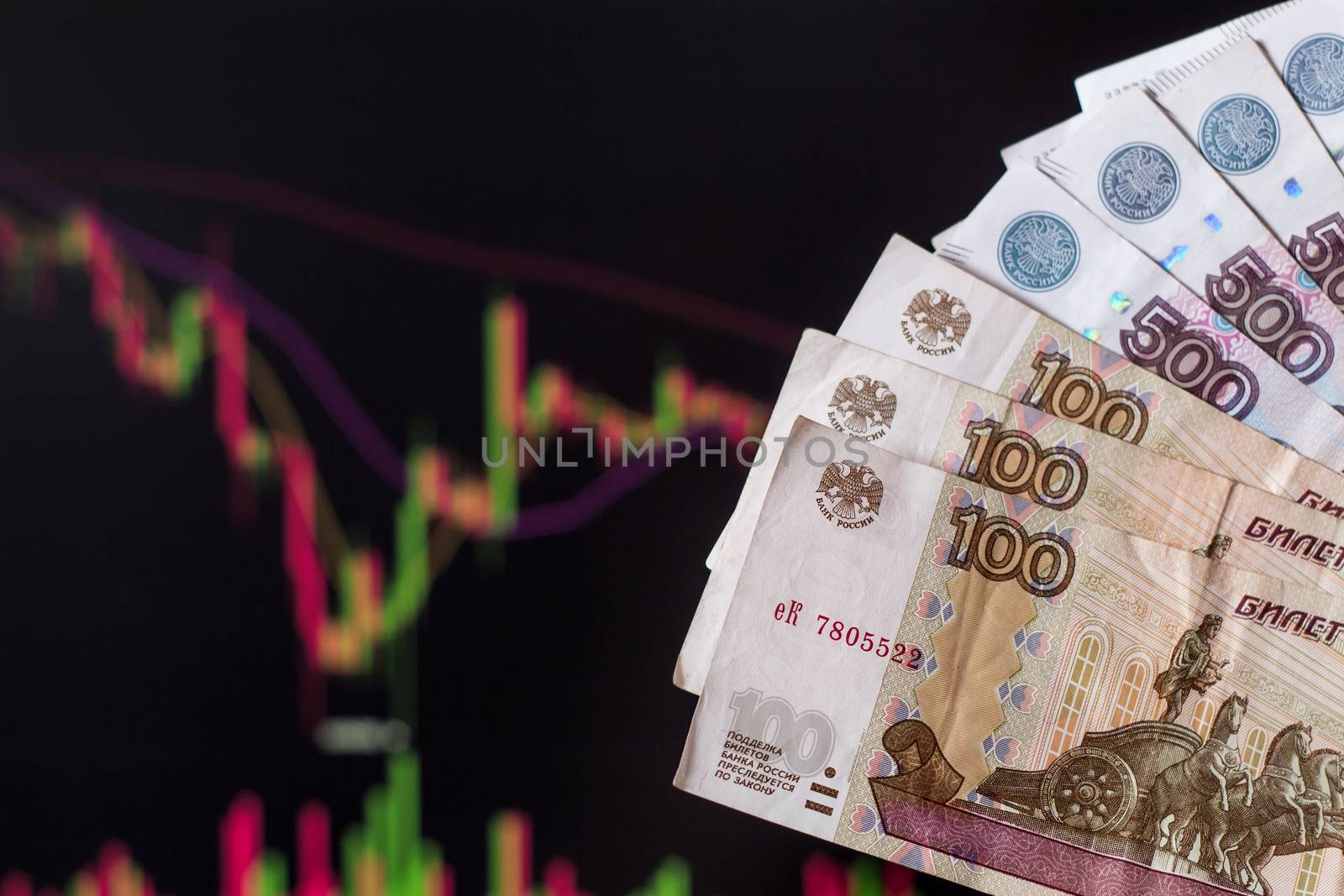 Russian rubles in front of a computer monitor with the currency  by YevgeniySam