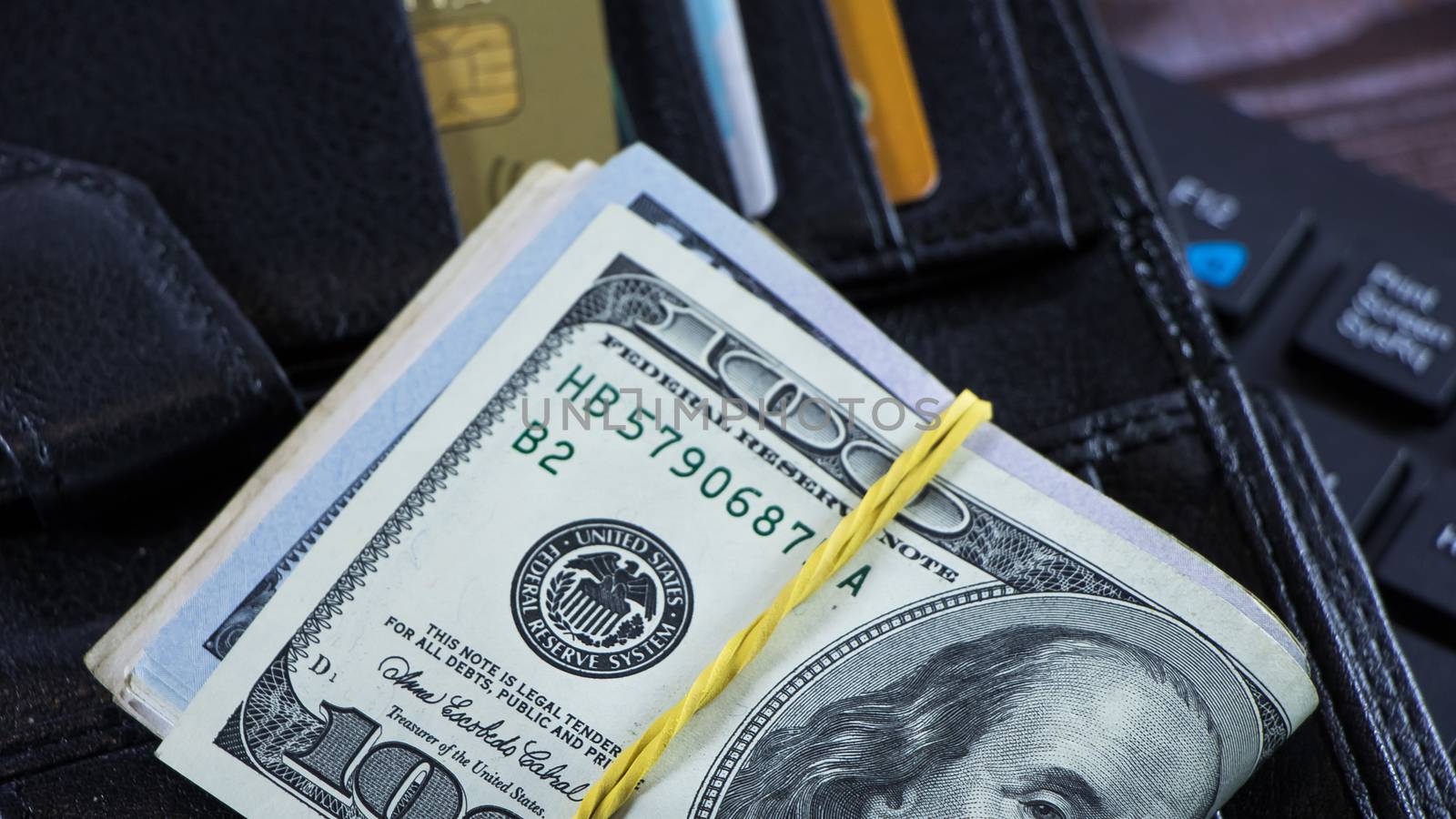 A stack of hundred-dollar bills is on the wallet in the form of  by YevgeniySam
